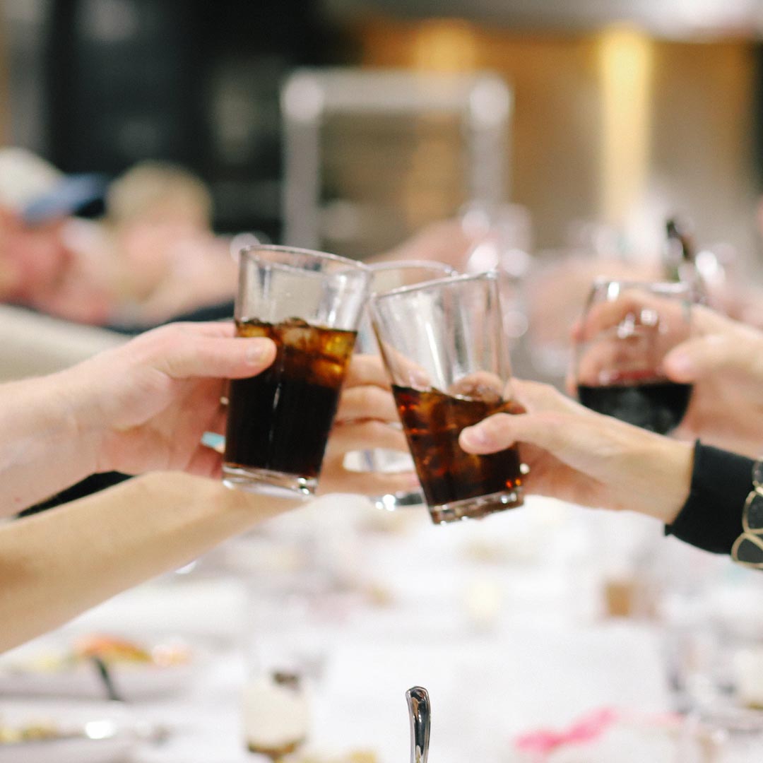 Employees raising a glass during team building event at Mirepoix above Holiday Market Royal Oak