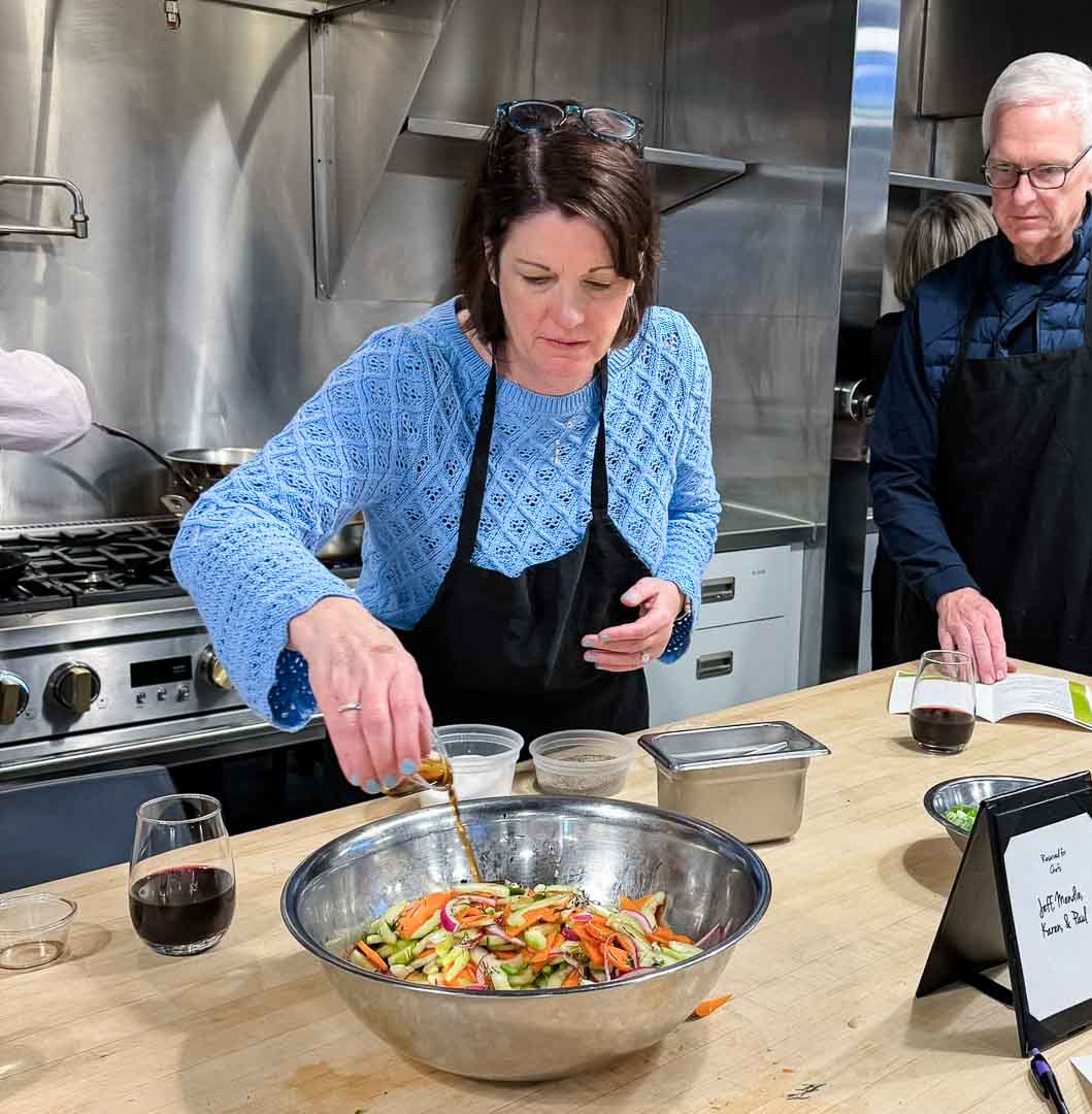 Student Chef in Cooking Class at Mirepoix Cooking School in Royal Oak, Michigan Above Holiday Market